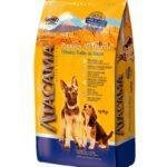 Saco de alimento Atacama Puppies All Breeds para cachorros de todas las razas, con envase amarillo y azul, imágenes de dos perros y beneficios nutricionales destacados en el empaque.