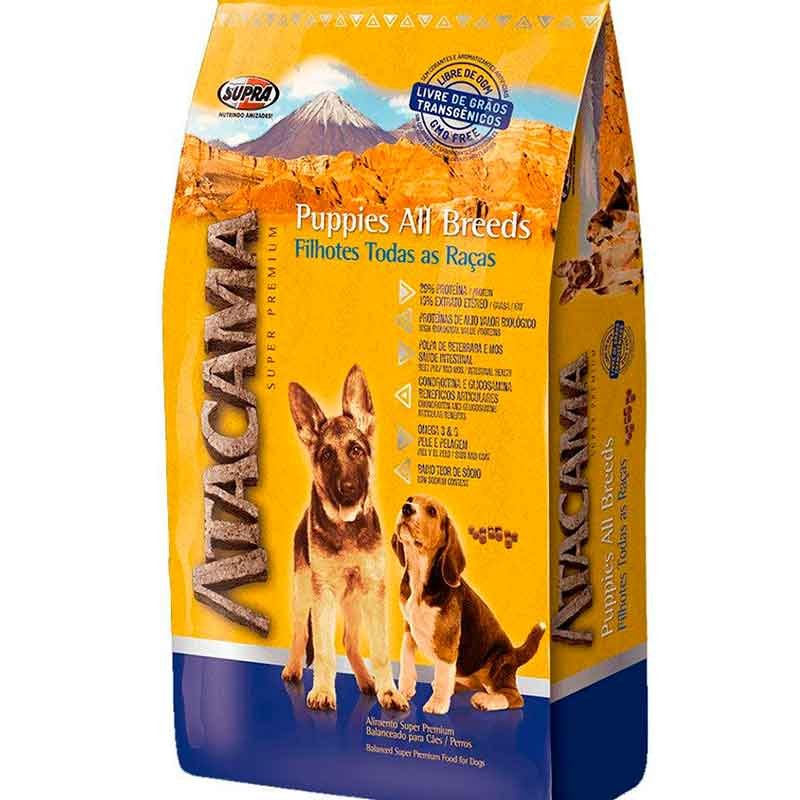 Saco de alimento Atacama Puppies All Breeds para cachorros de todas las razas, con envase amarillo y azul, imágenes de dos perros y beneficios nutricionales destacados en el empaque.
